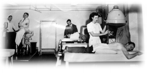 Leo is in center, rear, speaking with patient